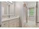 This bathroom has a shower/tub combo, tile flooring, and a large sink with a white vanity at 980 Fenimore Cir, Atlanta, GA 30350