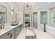 Stunning bathroom featuring dual sinks, a glass shower, and a luxurious soaking tub at 980 Fenimore Cir, Atlanta, GA 30350