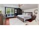 Spacious bedroom boasts a large window, modern ceiling fan, and neutral color palette at 980 Fenimore Cir, Atlanta, GA 30350