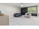 Bright bonus room features plush carpeting, stylish seating, and a decorative ceiling light fixture at 980 Fenimore Cir, Atlanta, GA 30350