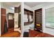 A large walk-in closet provides ample storage space with custom shelving and a full length mirror at 980 Fenimore Cir, Atlanta, GA 30350