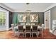 A modern dining room with seating for eight features stylish artwork and elegant lighting at 980 Fenimore Cir, Atlanta, GA 30350