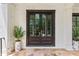 Elegant double front door framed by white brick and potted plants at 980 Fenimore Cir, Atlanta, GA 30350