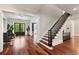 The foyer flows past comfortable seating to a staircase, creating a welcoming and stylish entrance at 980 Fenimore Cir, Atlanta, GA 30350