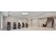 Spacious game room with an arcade setup, white tile flooring, and access to the dining room at 980 Fenimore Cir, Atlanta, GA 30350