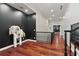 Upstairs hallway with hardwood flooring, black accent wall, and classic balustrade staircase at 980 Fenimore Cir, Atlanta, GA 30350