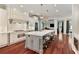 Spacious kitchen featuring a large island with seating, custom cabinets and hardwood floors at 980 Fenimore Cir, Atlanta, GA 30350