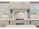 Elegant kitchen with marble countertops, custom cabinetry, and a stylish range hood at 980 Fenimore Cir, Atlanta, GA 30350