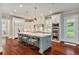 Open kitchen with stainless steel appliances, large island, hardwood floors and adjacent breakfast area at 980 Fenimore Cir, Atlanta, GA 30350