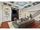 Elegant living room featuring a fireplace, built-in shelves, a modern chandelier and hardwood floors at 980 Fenimore Cir, Atlanta, GA 30350