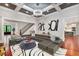 Elegant living room with modern decor, coffered ceiling, and open access to the staircase and kitchen at 980 Fenimore Cir, Atlanta, GA 30350