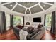 Bright living room featuring a ceiling fan, a fireplace, and large windows overlooking greenery at 980 Fenimore Cir, Atlanta, GA 30350
