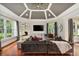 Bright living room featuring a ceiling fan, a fireplace, and large windows overlooking greenery at 980 Fenimore Cir, Atlanta, GA 30350