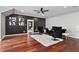 Spacious living room features a dark accent wall, hardwood floors, and contemporary decor at 980 Fenimore Cir, Atlanta, GA 30350