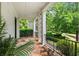 Inviting porch with a stone floor, iron railing, and view of the landscaped yard at 980 Fenimore Cir, Atlanta, GA 30350