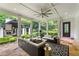 Inviting screened porch with comfortable seating and a picturesque view of the beautifully landscaped backyard at 980 Fenimore Cir, Atlanta, GA 30350