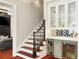 Elegant staircase with adjacent bar area featuring glass cabinets and beverage coolers, creating a luxurious touch at 980 Fenimore Cir, Atlanta, GA 30350