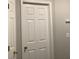 Interior door with traditional panel design and brass hardware with a dark wall at 985 Romer Pl, Stone Mountain, GA 30083