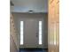 Welcoming entryway with decorative side windows flanking a front door with a dark rug at 985 Romer Pl, Stone Mountain, GA 30083