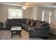 Comfortable living room features a large sectional sofa, ceiling fan, and natural light at 985 Romer Pl, Stone Mountain, GA 30083