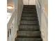 Staircase with wooden steps and a white handrail leading to the upper level at 985 Romer Pl, Stone Mountain, GA 30083