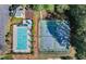 Aerial view of a community pool and tennis courts, providing recreational amenities for residents at 1008 Post Horn Run, Lawrenceville, GA 30045