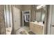 Bathroom featuring wallpaper, a vanity with a mirror, and a door leading to the bedroom at 1008 Post Horn Run, Lawrenceville, GA 30045