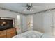 Cozy bedroom featuring a ceiling fan, neutral walls, and access to the ensuite bathroom and hallway at 1008 Post Horn Run, Lawrenceville, GA 30045