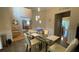 Spacious dining area with modern lighting, a glass table, and comfortable seating at 1008 Post Horn Run, Lawrenceville, GA 30045