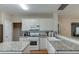 Bright kitchen featuring granite countertops, stainless steel appliances, and lots of natural light at 1008 Post Horn Run, Lawrenceville, GA 30045