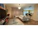 Open concept living space with a glass table, a modern entertainment center and bar seating at 1008 Post Horn Run, Lawrenceville, GA 30045