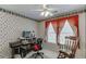 Bright home office featuring a large window, a ceiling fan, a desk, and chair at 1008 Post Horn Run, Lawrenceville, GA 30045