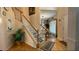Traditional staircase with wooden banisters and bright natural lighting at 1008 Post Horn Run, Lawrenceville, GA 30045