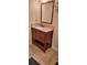 Bathroom vanity with dark wood cabinet, granite countertop and tiled backsplash with a framed mirror at 1638 Raleigh Cir, Marietta, GA 30067