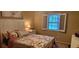Cozy bedroom featuring a comfortable bed, window with plantation shutters, and neutral wall color at 1638 Raleigh Cir, Marietta, GA 30067