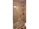 Modern bathroom shower featuring neutral tiling, glass door and updated fixtures at 1638 Raleigh Cir, Marietta, GA 30067