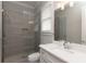 Modern bathroom featuring a glass shower, gray tiled walls, and a white vanity with stone countertop at 2909 Redding Road Northeast, Atlanta, GA 30319