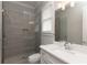 Modern bathroom featuring a glass shower door, sleek gray tiles, and a white vanity with stone countertop at 2909 Redding Road Northeast, Atlanta, GA 30319
