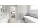 Elegant bathroom with marble countertops, a soaking tub, and a serene, inviting atmosphere at 2909 Redding Road Northeast, Atlanta, GA 30319