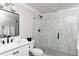 Bright bathroom featuring a white vanity, black hardware, and modern tiled shower with a glass door at 2909 Redding Road Northeast, Atlanta, GA 30319