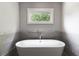 Modern bathroom featuring a freestanding tub with sleek fixtures under a bright window at 2909 Redding Road Northeast, Atlanta, GA 30319