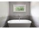 Modern bathroom with a white soaking tub under a window, creating a relaxing ambiance at 2909 Redding Road Northeast, Atlanta, GA 30319