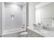Bathroom with white subway tile, gray vanity with marble top and tub with showerhead at 2909 Redding Road Northeast, Atlanta, GA 30319