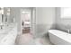 Luxury bathroom showcasing a standalone tub, marble countertop vanity, and neutral tile finishes at 2909 Redding Road Northeast, Atlanta, GA 30319