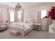 Charming bedroom featuring a white metal bed frame, soft pink accents and patterned wallpaper at 2909 Redding Road Northeast, Atlanta, GA 30319