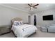 Inviting bedroom with neutral tones, soft bedding, a ceiling fan, and a cozy seating area at 2909 Redding Road Northeast, Atlanta, GA 30319