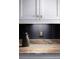 Close up of bar area with marble countertop, dark backsplash and white cabinets at 2909 Redding Road Northeast, Atlanta, GA 30319
