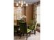 Close up on a dining room with a wood table, green chairs, and a modern chandelier at 2909 Redding Road Northeast, Atlanta, GA 30319