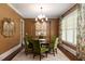 This formal dining room features green chairs, a round table, and an elegant area rug at 2909 Redding Road Northeast, Atlanta, GA 30319
