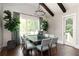 Dining area with vaulted ceilings, modern chandelier, large windows and a door to outside at 2909 Redding Road Northeast, Atlanta, GA 30319